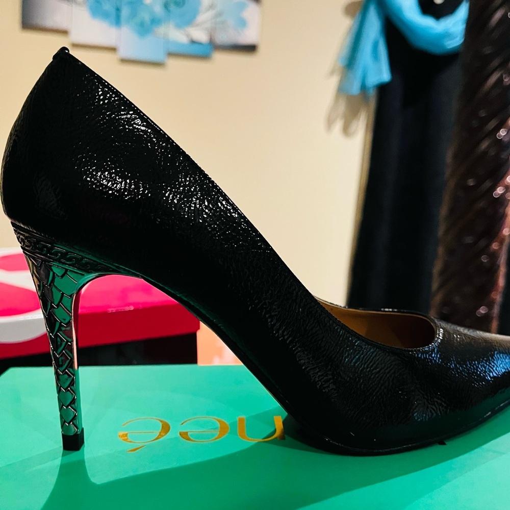 High heel black pump with silver heel.
